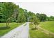 Long gravel driveway leading to a charming house at 1610 Woodards Dairy Rd, Middlesex, NC 27557
