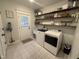 Well-organized laundry room with overhead storage and a modern washer and dryer at 1610 Woodards Dairy Rd, Middlesex, NC 27557