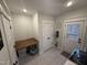 Bright laundry room featuring built-in folding table and storage options at 1610 Woodards Dairy Rd, Middlesex, NC 27557