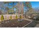 Cozy backyard with fire pit and wood chips at 1801 Liberty St, Durham, NC 27703