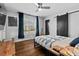 Bright bedroom with hardwood floors, a ceiling fan, and sliding barn door at 1801 Liberty St, Durham, NC 27703