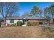 Charming single-story home with a combination of painted brick and wood siding, complemented by a well-maintained front yard at 1801 Liberty St, Durham, NC 27703