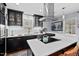 Modern kitchen featuring black cabinets, white subway tile, and stainless steel appliances and range hood at 1801 Liberty St, Durham, NC 27703