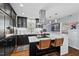 Stylish kitchen with black cabinets, white countertops, and a modern island with seating at 1801 Liberty St, Durham, NC 27703