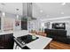 Modern kitchen with dark cabinetry, white quartz countertops, and stainless steel appliances at 1801 Liberty St, Durham, NC 27703