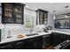 Modern kitchen with dark cabinetry, white quartz countertops, and stainless steel appliances at 1801 Liberty St, Durham, NC 27703