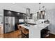 Modern kitchen with dark cabinetry, white quartz countertops, and stainless steel appliances at 1801 Liberty St, Durham, NC 27703