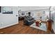 Open-concept living room featuring hardwood floors, a modern leather sofa, and a view into the kitchen at 1801 Liberty St, Durham, NC 27703