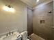 Bathroom with a tiled shower stall and a marble sink top at 190 Broadleaf Ln, Louisburg, NC 27549