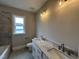 Luxurious bathroom featuring double sinks with marble countertops and brushed nickel faucets at 190 Broadleaf Ln, Louisburg, NC 27549