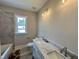 Bathroom featuring double sinks and a window at 190 Broadleaf Ln, Louisburg, NC 27549