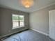 Bedroom featuring natural light from a window with exterior views and modern ceiling light at 190 Broadleaf Ln, Louisburg, NC 27549