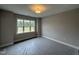 Bright bedroom with large windows offering great views and carpet flooring covered with protective wrap at 190 Broadleaf Ln, Louisburg, NC 27549