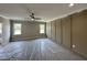 Spacious bedroom with neutral walls, two windows, a ceiling fan, and decorative trim at 190 Broadleaf Ln, Louisburg, NC 27549