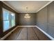Dining room with modern wainscoting, large window and contemporary lighting at 190 Broadleaf Ln, Louisburg, NC 27549