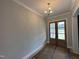 Dining room featuring double doors and stylish light fixture at 190 Broadleaf Ln, Louisburg, NC 27549