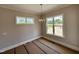 Bright dining room with modern light fixture, neutral walls, and ample natural light at 190 Broadleaf Ln, Louisburg, NC 27549