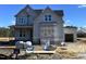 Two-story home with gray siding and architectural details under construction on a sunny day at 190 Broadleaf Ln, Louisburg, NC 27549