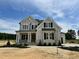Beautiful two-story home featuring a stone facade, dark shutters, and professionally landscaped front yard at 190 Broadleaf Ln, Louisburg, NC 27549