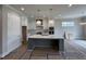 Spacious kitchen with pendant lights, stainless appliances, and large island at 190 Broadleaf Ln, Louisburg, NC 27549