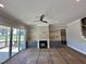 Inviting living room featuring a stone fireplace, built-in cabinets, and a sliding glass door at 190 Broadleaf Ln, Louisburg, NC 27549