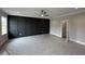 Main bedroom with modern black accent wall and neutral paint at 190 Broadleaf Ln, Louisburg, NC 27549