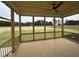 Inviting screened porch with wood flooring, ceiling fan, and tranquil views of the surrounding landscape at 190 Broadleaf Ln, Louisburg, NC 27549