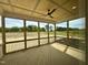 Screened porch with wood floor and ceiling fan overlooks yard at 190 Broadleaf Ln, Louisburg, NC 27549