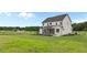 Side and back view of this home featuring the landscaped backyard and a screened in porch at 190 Broadleaf Ln, Youngsville, NC 27596