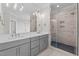 Elegant bathroom featuring a double vanity, a glass-enclosed shower, and modern fixtures at 190 Broadleaf Ln, Youngsville, NC 27596