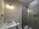 Bathroom featuring a marble vanity, tiled walk-in shower with glass door, and recessed lighting at 190 Broadleaf Ln, Youngsville, NC 27596