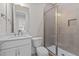 Bathroom with a modern vanity, marble countertop, and a frameless glass walk-in shower at 190 Broadleaf Ln, Youngsville, NC 27596
