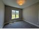 Comfortable bedroom with plush carpeting, base molding, and a view of the backyard at 190 Broadleaf Ln, Youngsville, NC 27596