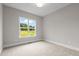 Bright bedroom with a large window offering scenic outdoor views and natural light at 190 Broadleaf Ln, Youngsville, NC 27596