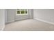 Bright bedroom with plush carpet and a large window providing ample natural light and outdoor views at 190 Broadleaf Ln, Youngsville, NC 27596