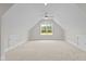 Finished attic bonus room with carpeting, storage and natural light from the large window at 190 Broadleaf Ln, Youngsville, NC 27596