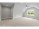 Spacious bonus room featuring plush carpeting, a ceiling fan, and natural light from window at 190 Broadleaf Ln, Youngsville, NC 27596