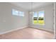 Bright dining room with large windows offering scenic views of the outdoors and a chandelier at 190 Broadleaf Ln, Youngsville, NC 27596