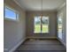 Sunny dining area with backyard views, classic lighting, and an exterior patio door at 190 Broadleaf Ln, Youngsville, NC 27596