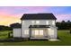 Back of this home at dusk, showcasing the back of the home and a screened in porch at 190 Broadleaf Ln, Youngsville, NC 27596