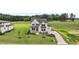 Charming two-story home showcasing a beautifully landscaped yard and a welcoming covered front porch at 190 Broadleaf Ln, Youngsville, NC 27596