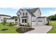 Stunning two-story home with a spacious three-car garage and manicured landscaping at 190 Broadleaf Ln, Youngsville, NC 27596