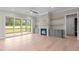 Inviting living room with a stone fireplace, built-in shelves, and access to a screened porch at 190 Broadleaf Ln, Youngsville, NC 27596