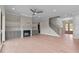 Open living room featuring a fireplace, custom built-ins, and staircase to the second floor at 190 Broadleaf Ln, Youngsville, NC 27596