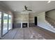 Cozy living room with a stone fireplace, built-in shelving, and sliding door access at 190 Broadleaf Ln, Youngsville, NC 27596