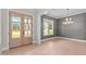 Elegant living room with beautiful hardwood floors, gray walls, and modern chandelier at 190 Broadleaf Ln, Youngsville, NC 27596