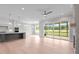Open concept living space combining kitchen, dining area, and access to the outdoor screened porch at 190 Broadleaf Ln, Youngsville, NC 27596