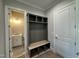 The mudroom features a bench and cubbies, with a view into the home's powder room at 190 Broadleaf Ln, Youngsville, NC 27596