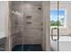 Modern shower with dual shower heads, a built-in niche, and a glass door at 190 Broadleaf Ln, Youngsville, NC 27596