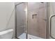 Modern tiled walk-in shower with mosaic tile floor and niche, enclosed in frameless glass at 190 Broadleaf Ln, Youngsville, NC 27596